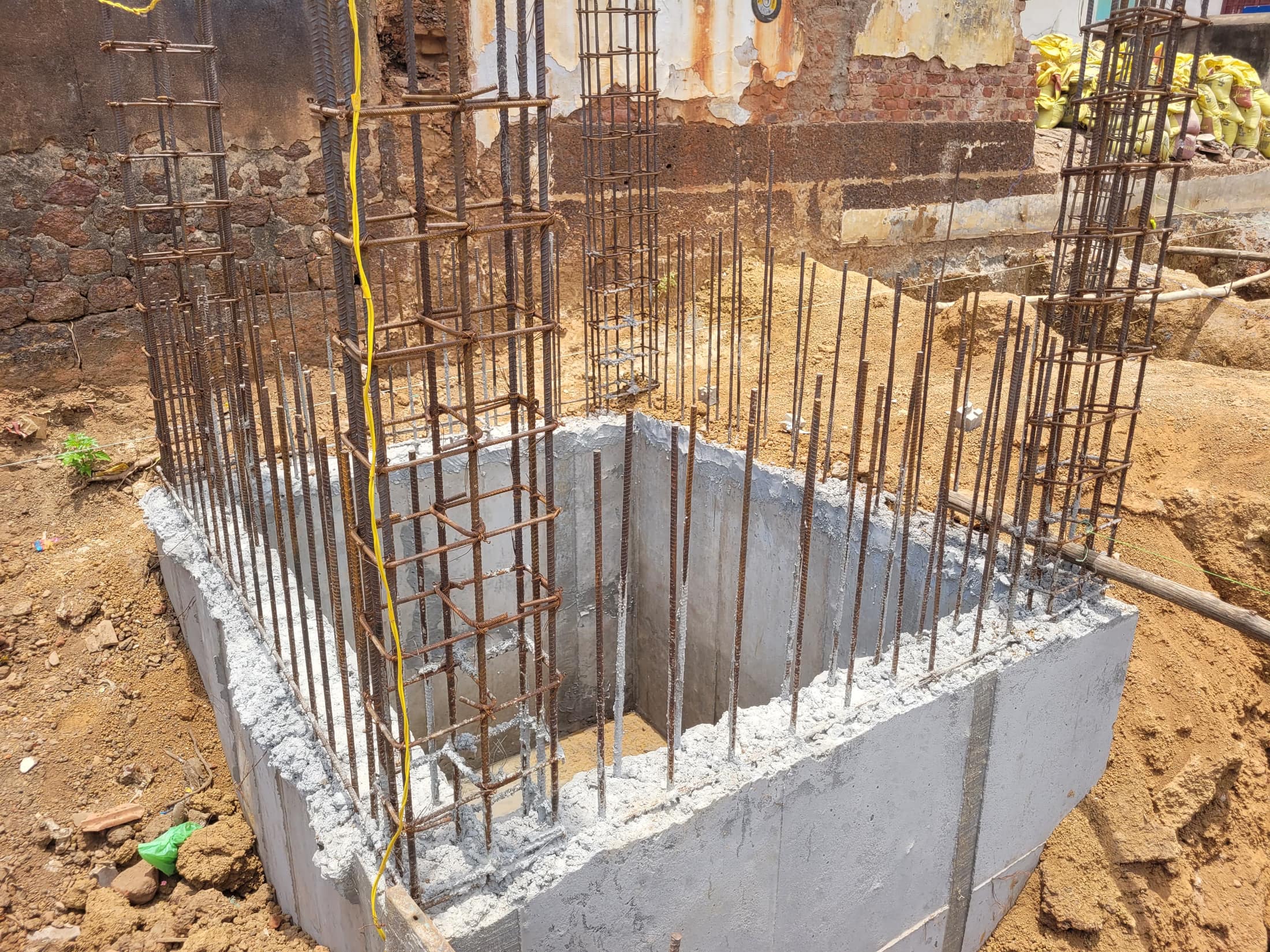 Karupar Sai Residency — foundation footing close-up, April 2026